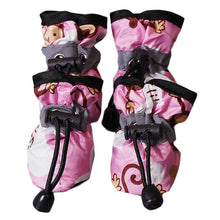 Pink Cute Dog Shoes on small puppy standing outdoors.